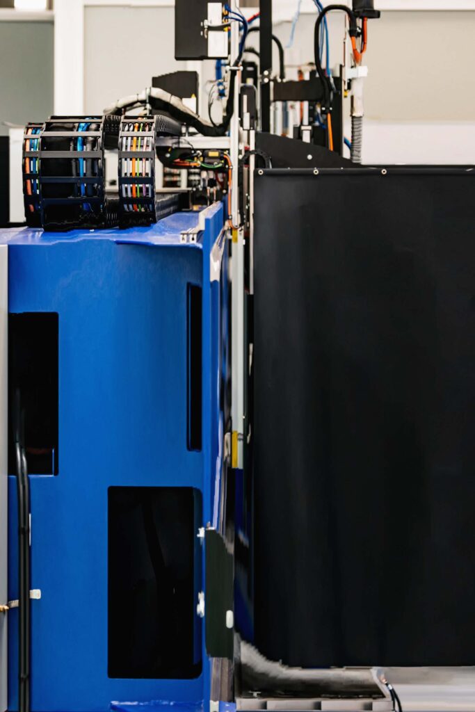Young woman controlling home with a digital touch screen panel installed on the wall in the living room. Concept of a smart home and mobile application for managing smart devices at home